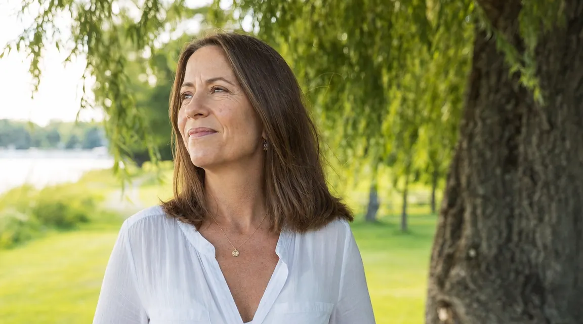 Woman outdoors in soft sunlight, glowing skin, no visible sunscreen residue or white cast